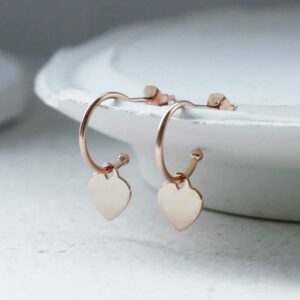 Rose Gold Heart Hoops on white plaster detail