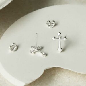 Sterling Silver Cross Stud Earrings on curved white background