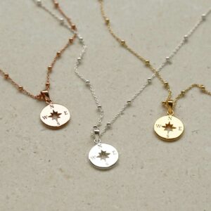 Three wanderlust necklaces in silver, gold and rose gold on satellite chains.