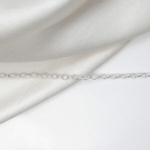 sterling silver oval belcher chain laid straight on linen