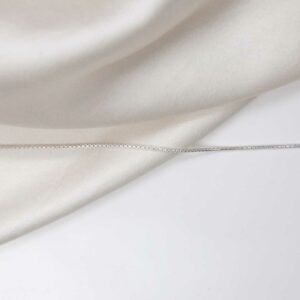 sterling silver round box chain laid straight on linen