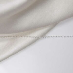 sterling silver trace chain laid straight on linen