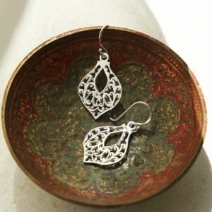 silver fleur de lis earrings in terracotta bowl