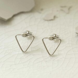 silver plain triangle studs on broken porcelain