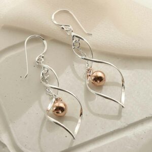 sterling silver twisted dangly earrings with centre rose gold ball on tile