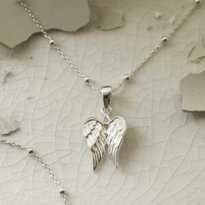 silver attached wings necklace on satellite chain