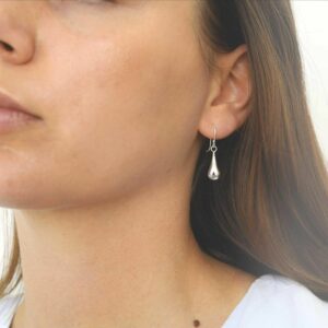 silver small liquid drop dangly earrings on model