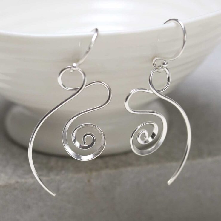 ME522_Sterling Silver Twirling Ribbon Dangly Earrings_5 Sterling Silver Twirling Ribbon Dangly Earrings on jewellery dish