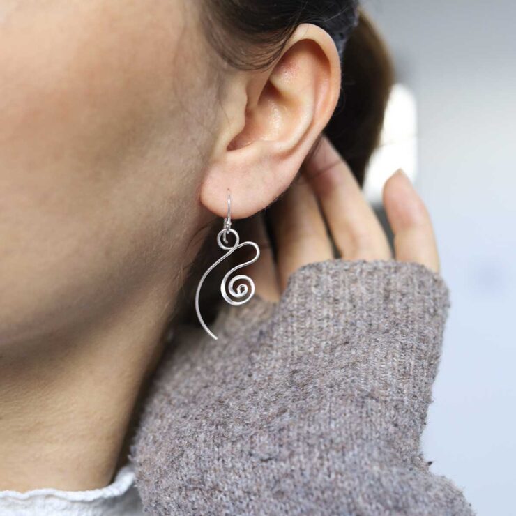 Sterling Silver Twirling Ribbon Dangly Earrings on model