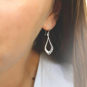 silver swirls in teardrop earrings on model