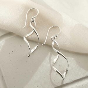 silver twisted ellipse earrings on linen