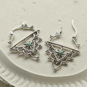 silver exotic hoops with turquoise dot on tile