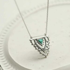 silver exotic necklace with turquoise triangle hanging