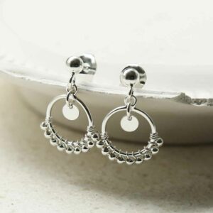 silver balls on hoop studs hanging