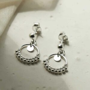 silver balls on hoop studs on tile