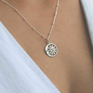 silver vintage sun and moon necklace on model