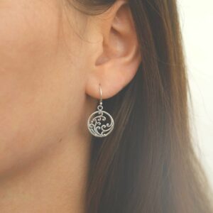 silver frothing waves in circle dangly earrings on model