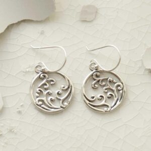 silver frothing waves in circle dangly earrings on tile