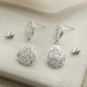 silver teardrop wiry nest earrings taken apart on tile