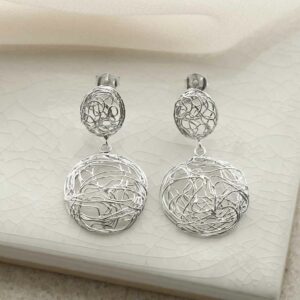 silver teardrop wiry nest earrings on tile