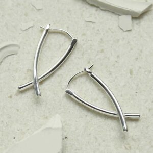 silver crossover bar hoops on stone