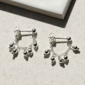 STERLING SILVER HANGING LANTERNS STUD CHAIN EARRINGS on table