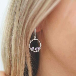 three amethyst gems in water droplets circle dangly earrings on model