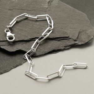 silver plain paperclip bracelet strewn on slate