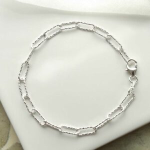 silver hammered paperclip bracelet laid in circle