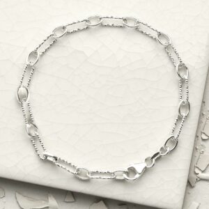 silver round and hammered linked bracelet laid in circle