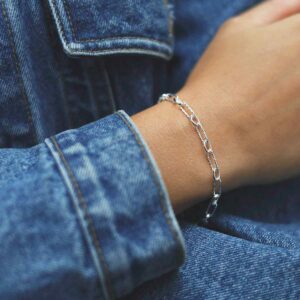 model wearing silver round and hammered linked bracelet in denim jacket