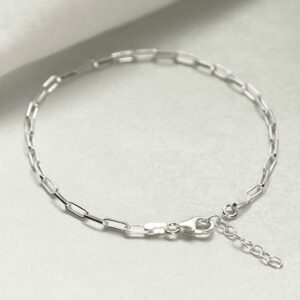 silver thinly linked paperclip bracelet laid in circle