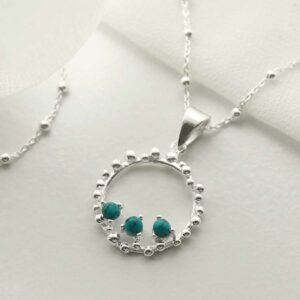 three turquoise gems in water droplets circle pendant on chain