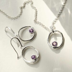 single amethyst gem in oval dangly earrings and necklace