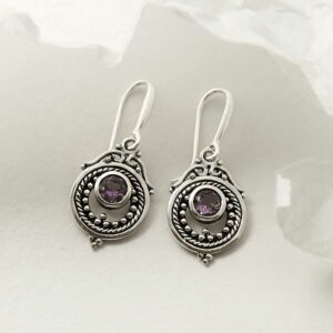 single amethyst gem in decorative dangly earrings