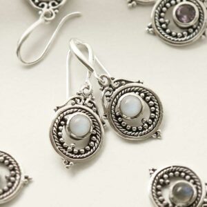 single moonstone gem in decorative dangly earrings