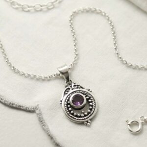 single amethyst gem in decorative necklace