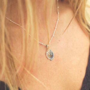 single labradorite gem in decorative necklace on model