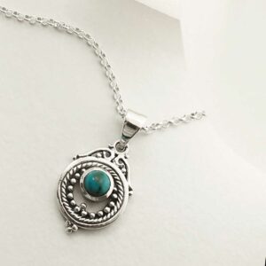 single turquoise gem in decorative necklace