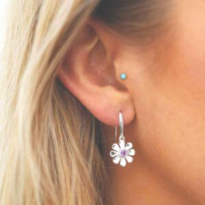 single amethyst gem in centre of daisy earrings on model