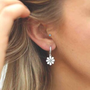 single labradorite gem in centre of daisy earrings on model