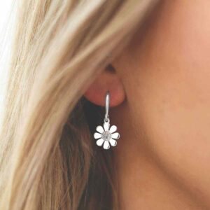 single moonstone gem in centre of daisy earrings on model