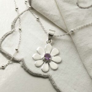 single amethyst gem in centre of daisy pendant