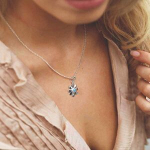 single opalite gem in centre of daisy pendant on model