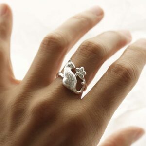 silver detailed cat and flower adjustable ring on hand