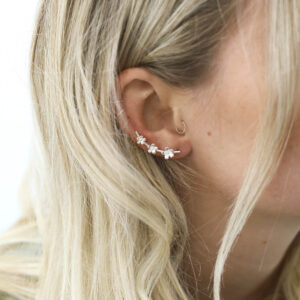 Blonde model wearing sterling silver triple flower ear climber