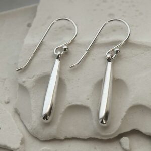 silver round rod baton dangly earrings laid straight