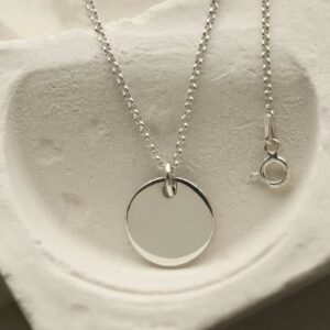 medium silver circle tag hanging from chain