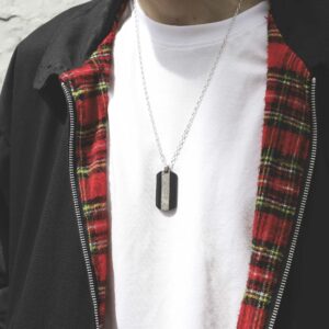 meteorite and carbon fibre dog tag necklace on male model