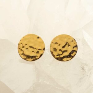 gold hammered disc stud earrings on crystal background